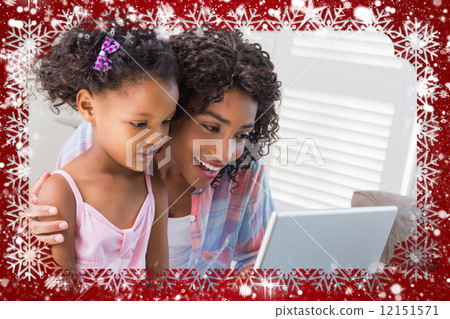 Cute daughter using laptop at desk with mother Cute daughter using laptop at desk with mother 12151571