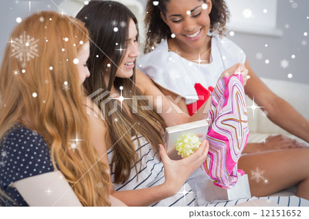 Composite image of cheerful young women surprising friend with a 12151652