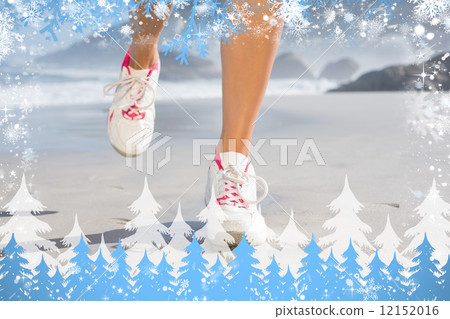 Composite image of fit woman walking on the beach 12152016