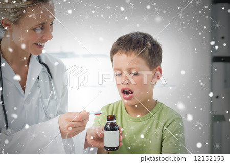 Doctor giving little boy cough syrup 12152153