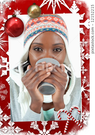 Composite image of young woman enjoying tea in the cold 12152215