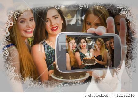 Hand holding smartphone showing photo 12152216