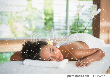 Gorgeous woman lying on massage table with salt treatment on back Gorgeous woman lying on massage table with salt treatment on back 12152540