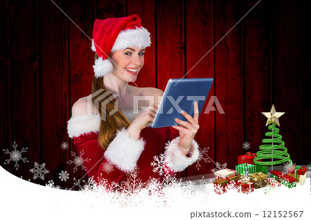 Composite image of pretty santa girl using tablet pc Composite image of pretty santa girl using tablet pc 12152567