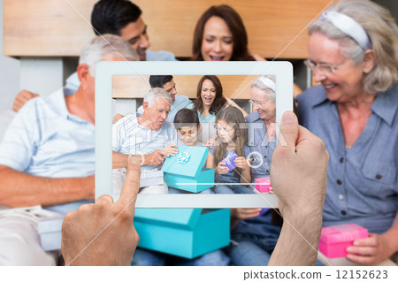 Composite image of hand holding tablet pc Composite image of hand holding tablet pc 12152623