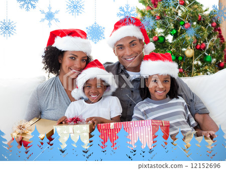Composite image of family holding christmas presents Composite image of family holding christmas presents 12152696