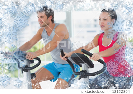 Fit young couple working out at spinning class 12152804