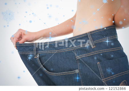 Close up of a woman belly in too big pants 12152866