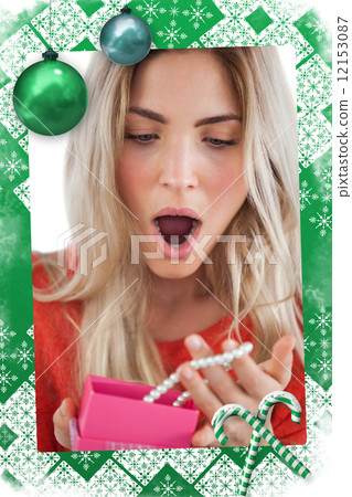 Shocked woman discovering necklace in a gift box 12153087