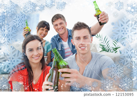 Group of friends celebrating by clinking bottles together 12153095