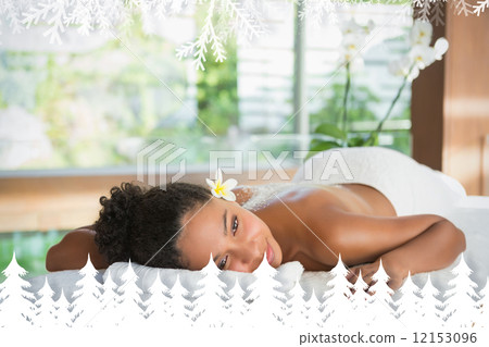 Gorgeous woman lying on massage table with salt treatment on back 12153096