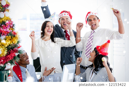 Business team punching the air to celebrate christmas 12153422