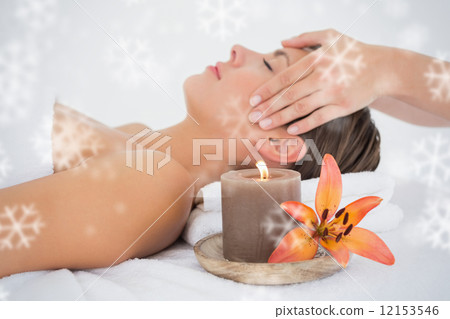 Attractive woman receiving head massage at spa center Attractive woman receiving head massage at spa center 12153546