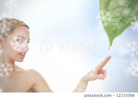 Blonde reaching out to dew drop falling from leaf 12153566