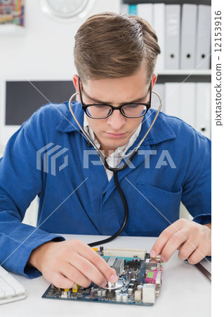 Technician listening to cpu with stethoscope 12153916