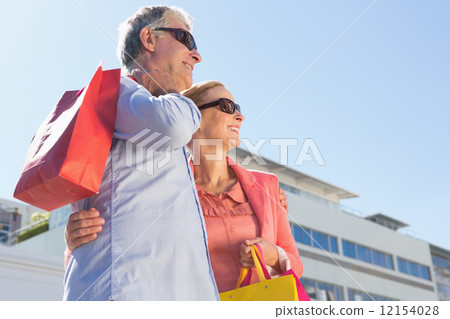Happy senior couple holding shopping bags Happy senior couple holding shopping bags 12154028