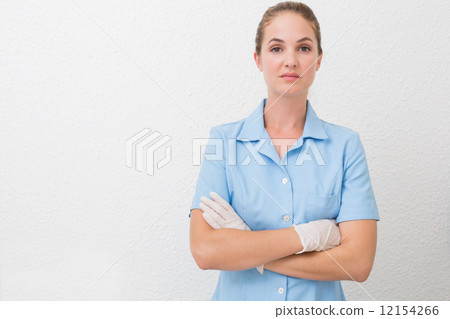 Serious dental assistant looking at camera 12154266