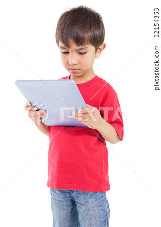 Cute little boy using tablet pc Cute little boy using tablet pc 12154353
