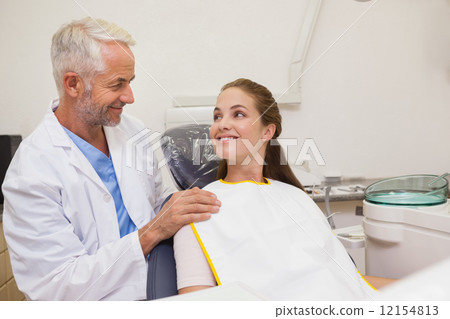 Dentist and patient smiling at each other 12154813