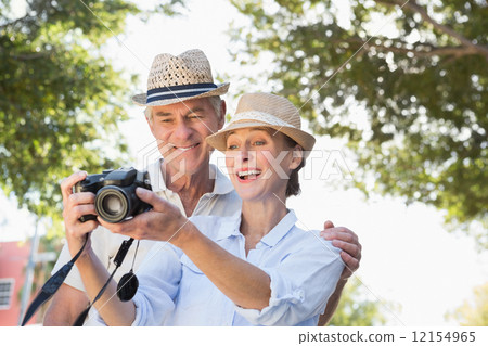 Happy senior couple looking at their camera Happy senior couple looking at their camera 12154965