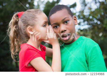 Cute children sharing gossip outside Cute children sharing gossip outside 12154966