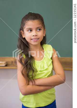 Cute pupil standing in classroom Cute pupil standing in classroom 12155141