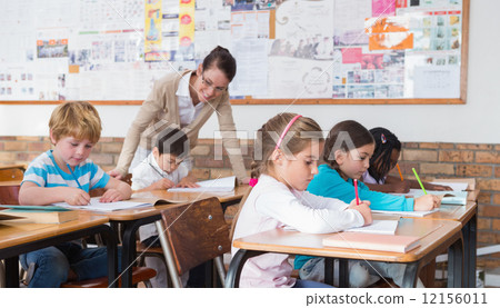 Cute pupils drawing at their desks Cute pupils drawing at their desks 12156011