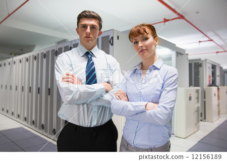 Confident data technicians looking at camera 12156189