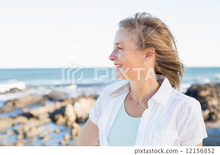 Casual woman smiling by the sea 12156852