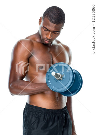 Determined fit shirtless young man lifting dumbbell Determined fit shirtless young man lifting dumbbell 12156866