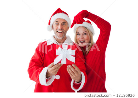 Festive couple smiling and holding gift 12156926