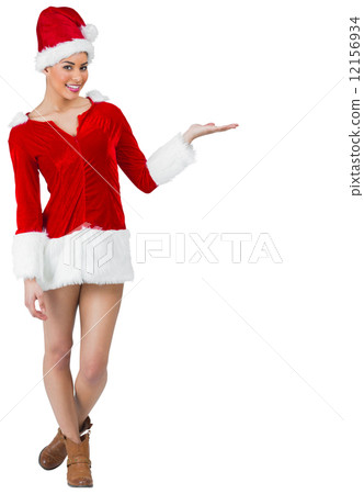 Pretty santa girl smiling at camera and presenting 12156934