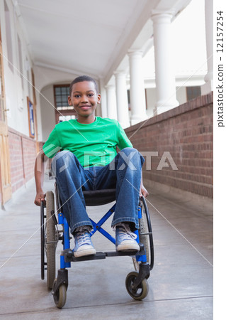 Cute disabled pupil smiling at camera in hall Cute disabled pupil smiling at camera in hall 12157254
