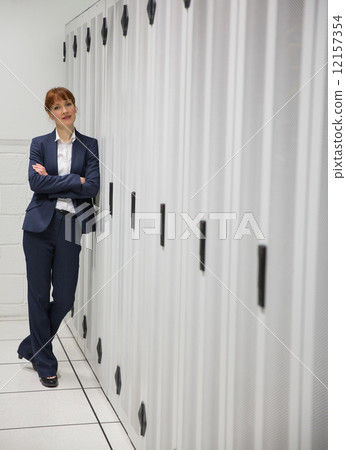 Pretty computer technician looking at camera 12157354