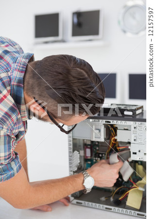 Computer engineer working on broken console 12157597