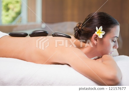 Beautiful woman receiving stone massage at health farm Beautiful woman receiving stone massage at health farm 12157677