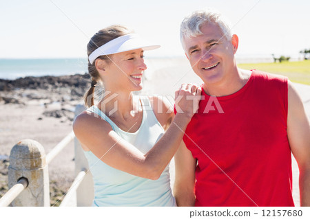 Fit mature couple warming up together on the pier Fit mature couple warming up together on the pier 12157680