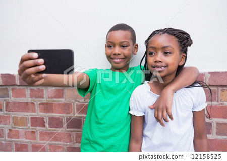 Cute pupils taking a selfie in the corridor Cute pupils taking a selfie in the corridor 12158525
