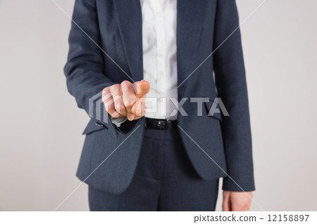 Businesswoman in suit pointing finger 12158897