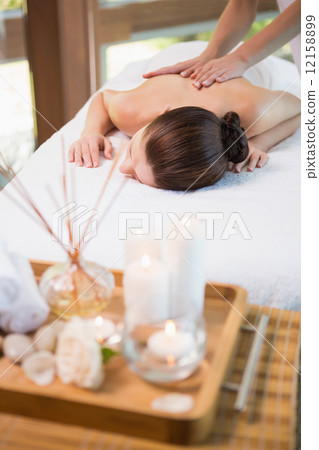 Attractive woman receiving back massage at spa center 12158899