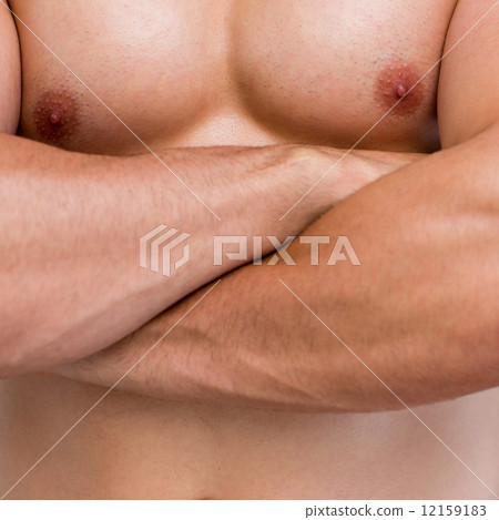 Mid section of shirtless muscular man with arms crossed Mid section of shirtless muscular man with arms crossed 12159183