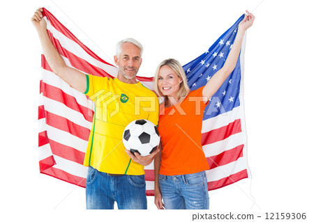 Football fan couple cheering and smiling at camera 12159306
