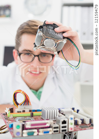 Smiling technician working on broken fan Smiling technician working on broken fan 12159479