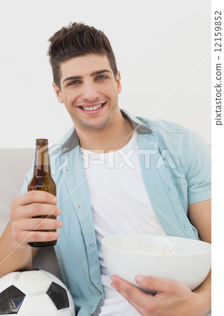 Happy soccer fan watching tv 12159852