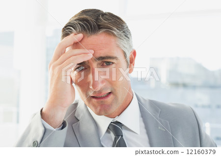 Businessman suffering from a headache Businessman suffering from a headache 12160379