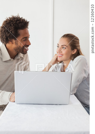 Happy couple on a date using laptop Happy couple on a date using laptop 12160410