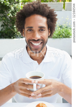 Smiling man having a coffee 12160544