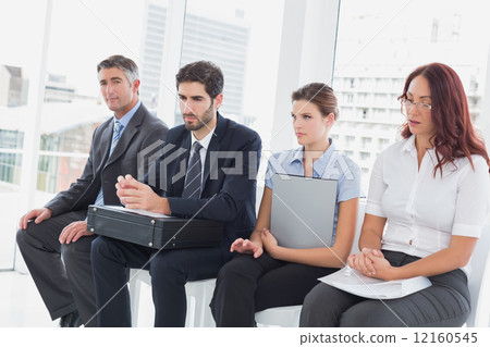 Serious business people sitting together 12160545