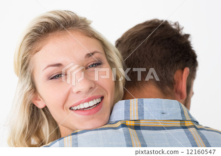 Close up of happy young couple embracing 12160547