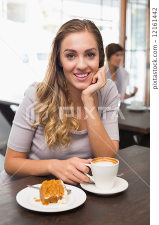 Pretty blonde enjoying cake and coffee Pretty blonde enjoying cake and coffee 12161442